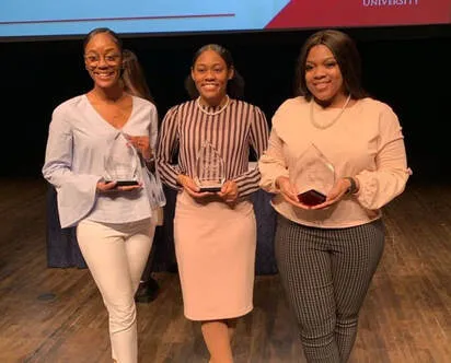 Asiha celebrating with a pink bottle